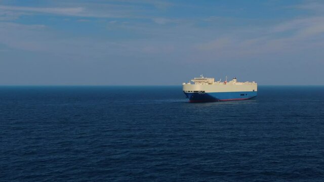 A large ship for transporting goods across the ocean. Rollers. Trailer vessels. Ro-Ro type vessel. A huge ship for transporting cars and equipment. Aerial  4K shot.