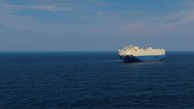 A large ship for transporting goods across the ocean. Rollers. Trailer vessels. Ro-Ro type vessel. A huge ship for transporting cars and equipment. Aerial  4K shot.