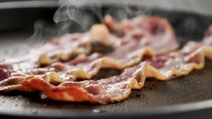 bacon frying in pan, slow motion