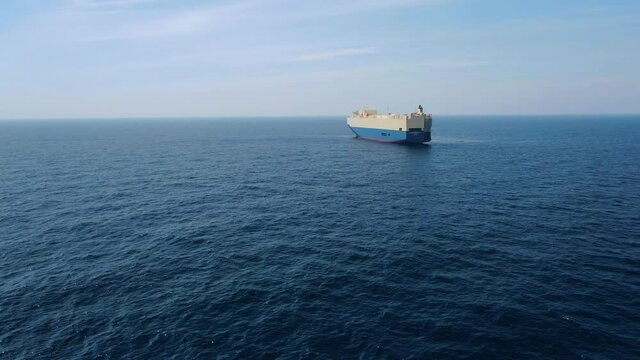 A large ship for transporting goods across the ocean. Rollers. Trailer vessels. Ro-Ro type vessel. A huge ship for transporting cars and equipment. Aerial  4K shot.