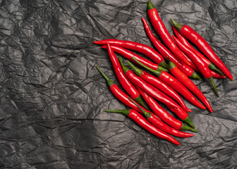 red hot chili pepper lines on crumpled black paper