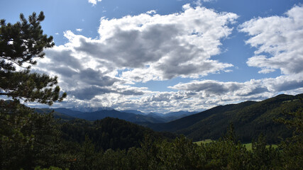 Fototapeta premium Landscape with intense clouds, hills and mountains, light and shadows, Schneebergland