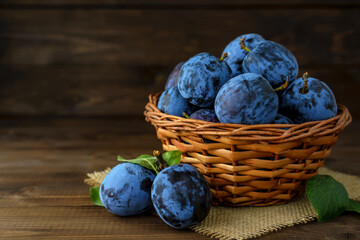 Ripe juicy plums in a basket