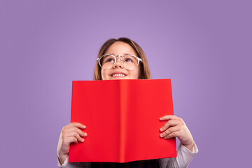 Excited schoolgirl with red book