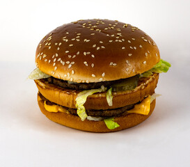 Burger with beef cutlet on a white plate.