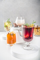 Various autumn winter alcohol drinks set. Different seasonal alcohol cocktails - mulled wine, glogg, grog, eggnog, ginger ale, hot buttered rum, punch, apple cider, sangria, white background