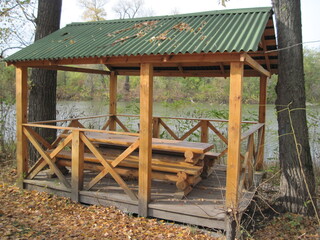 wooden house in the forest.Rest time in natural wooden bower on a sunny day in beautiful time of golden autumn. Relax with comfort in wild nature. 