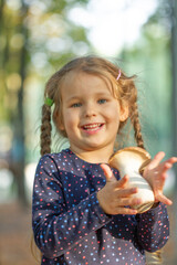Steppe white mushroom -pleurotus eryngii in the hands of a little pretty girl, close-up shot,...