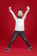 Excited boy with headphones celebrating success