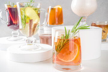 Various autumn winter alcohol drinks set. Different seasonal alcohol cocktails - mulled wine, glogg, grog, eggnog, ginger ale, hot buttered rum, punch, apple cider, sangria, white background