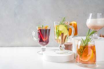 Various autumn winter alcohol drinks set. Different seasonal alcohol cocktails - mulled wine, glogg, grog, eggnog, ginger ale, hot buttered rum, punch, apple cider, sangria, white background