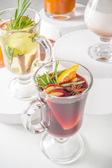Various autumn winter alcohol drinks set. Different seasonal alcohol cocktails - mulled wine, glogg, grog, eggnog, ginger ale, hot buttered rum, punch, apple cider, sangria, white background