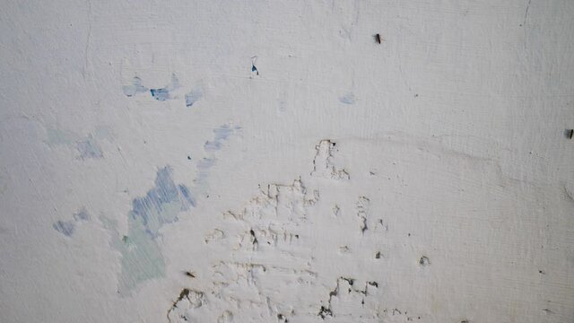 Putty wall aligning with plaster in room, renovation construction works and overhaul, closeup view. Finishing repairing works. Texture of gray cement plaster. Plastering coating wall surface
