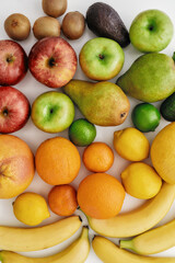 Close up of various colorful fresh summer fruits isolated over white background