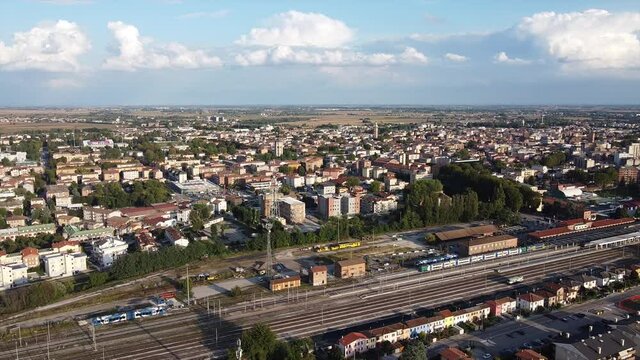 
aerial drone view on Rovigo city with railroad and moving trains