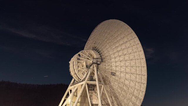 Large Radio Telescope under a Starry Sky (Time Lapse/Tilt Up)