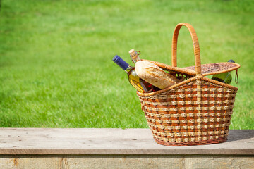 Picnic basket with wine and baguette