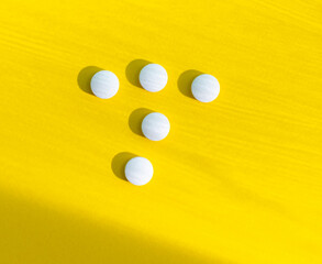 White pills with copy space on yellow background, Healthy and Medicine concept.