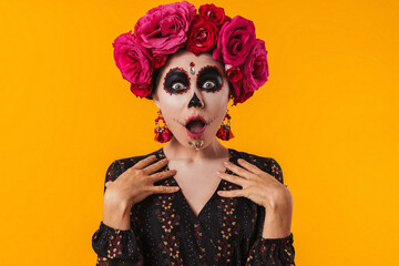 Photo of girl in halloween makeup and flower wreath posing at camera