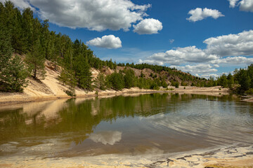 Large quarry for the extraction of clay, inactive, reclaimed. Trees grew on its territory and a...