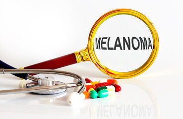 Magnifying lens with text MELANOMA with medical tools