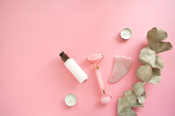 Massage with a quartz roller for the face with pink natural jade. Gouache massage tool, with beauty...