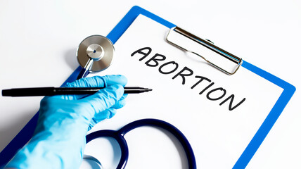 Paper with text ABORTION on a table with stethoscope
