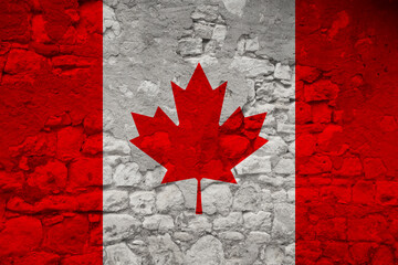 seamless panorama of the national flag of the state of Canada on an old stone wall with cracks, the...