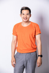 Portrait young handsome man in a blank orange t-shirt on white background.