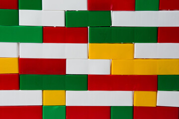 A wall of plastic building blocks. Background from multi-colored details of the children's designer