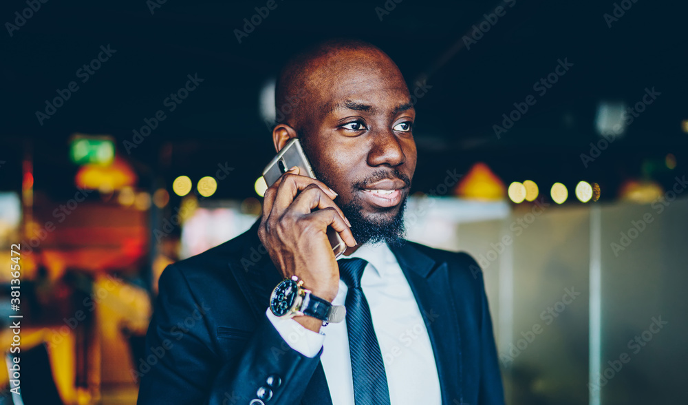 Aufkleber dark skinned businessman in formal apparel using cellular application for calling to operator, afric