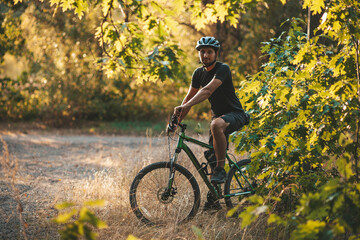 Fototapeta na wymiar Bicycle rider in the forest, active lifestyle. Training in nature, fresh air.