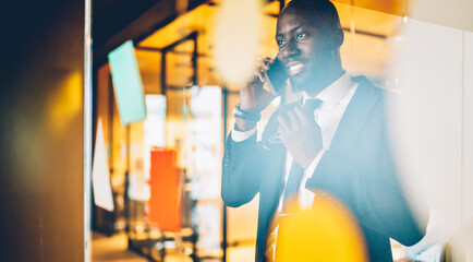 Dark skinned executive manager connecting to office wireless for making contact calling, successful professional lawyer communicating with customer discussing corporate meeting in workspace