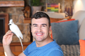 Man holding stunning white parrot