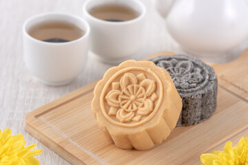 Obraz na płótnie Canvas Colorful beautiful moon cake, mung bean cake, Champion Scholar Pastry cake for Mid-Autumn festival traditional gourmet dessert snack, close up.