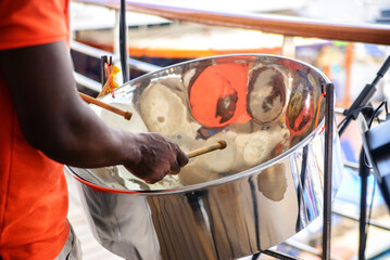 man is playing on a steel drums at cruise ship open deck - obrazy, fototapety, plakaty