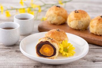 Moon cake yolk pastry, mooncake for Mid-Autumn Festival holiday, top view design concept on bright wooden table with copy space