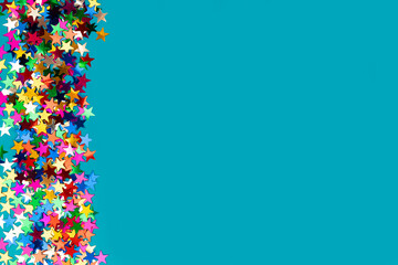 colorful stars confetti isolated on blue background