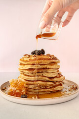 stack of pancakes with honey