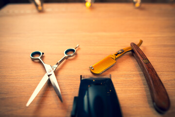 Close up of accessories for barber shop. Scissors, razor, trimmer.