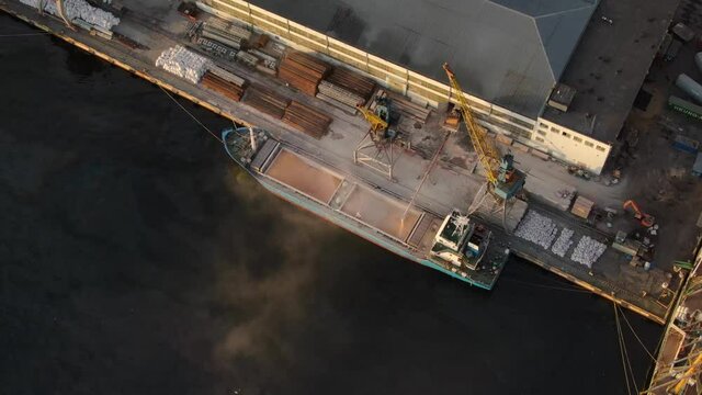 Loading of wheat grain on a bulk carrier at the ship's pier in the port of Vladivostok.