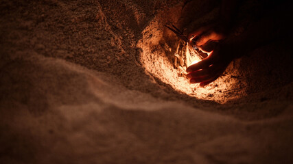tourist makes a fire on the beach