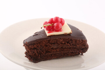 piece of chocolate cake with red fruits topping