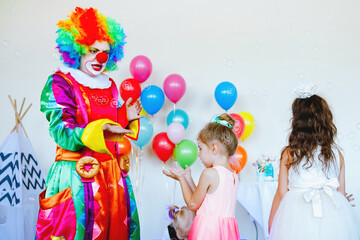Children play with a clown