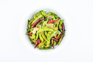 A pot of delicious spicy edamame on white background