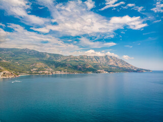 Fototapeta na wymiar Beautiful view from sea to Budva coast on background of mountains, Montenegro. Drone aerial photo