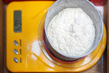 Bowl with flour on kitchen scale