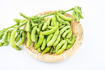 Fresh edamame in a pot on white background