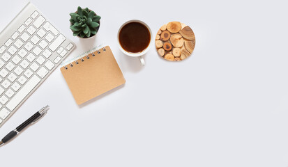 white office desk background with smartphone with blank screen mockup, laptop computer, coffee cup and accessories. Top view with copy space, flat lay.