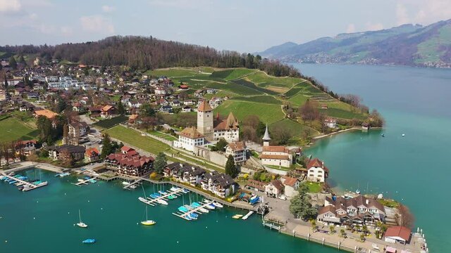 Aerial footage of the Spiez caslte by lake Thun in the Bern Canton in Switzerland. Shot with a tilt down motion